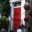 House with Red Front Door Hanging Baskets